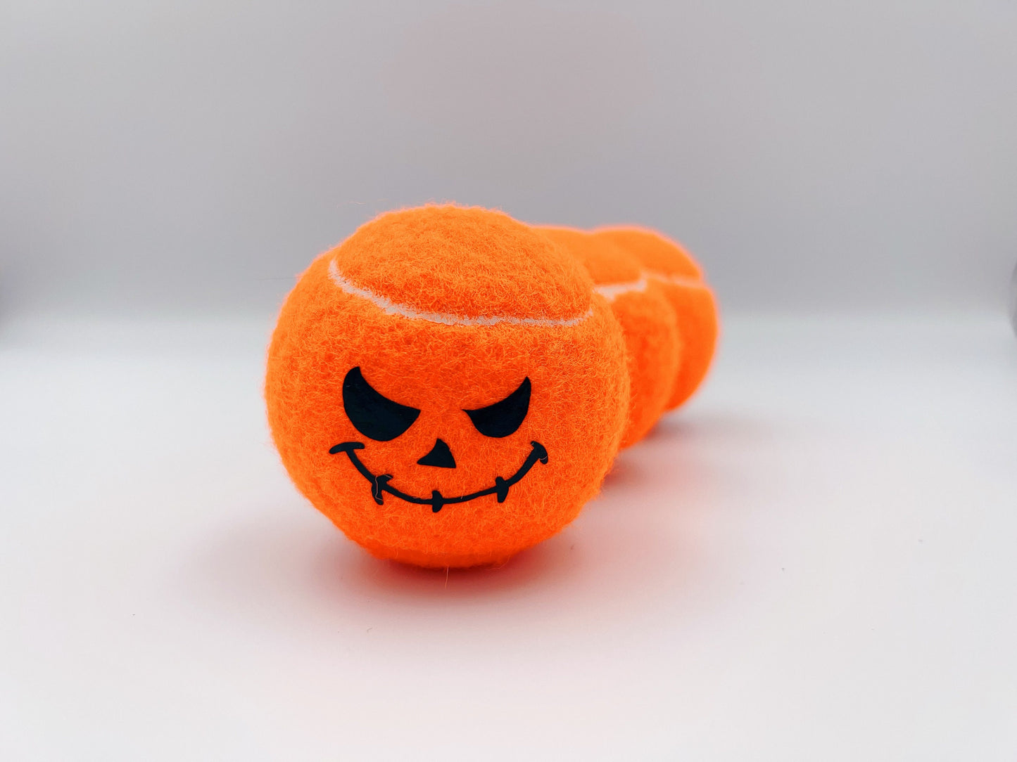 Three Haunted Halloween Tennis Balls